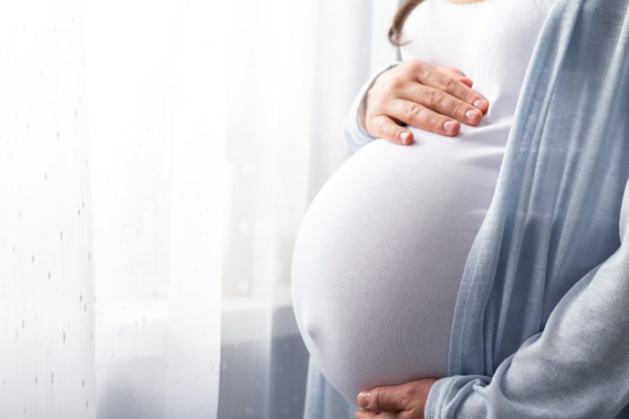 healthy pregnancy. Side view pregnant woman with big belly advanced pregnancy in hands. Banner copyspace for text. Elegant mother waiting baby.